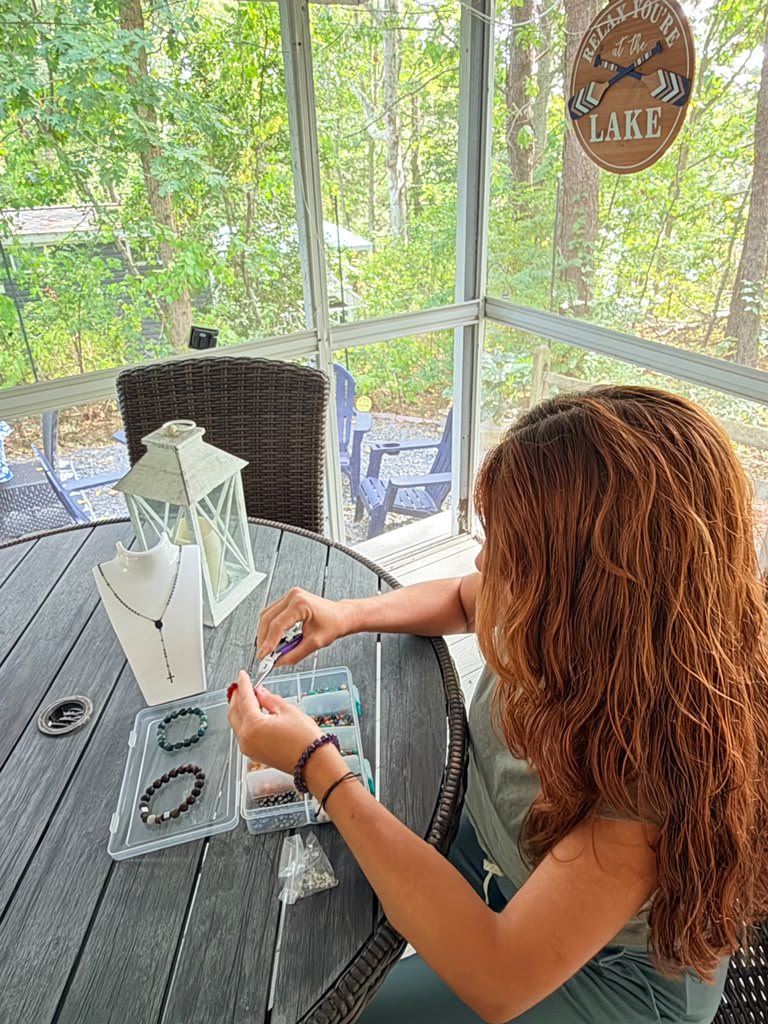 The founder of El Jardín de los Ángeles making rosaries and bracelets